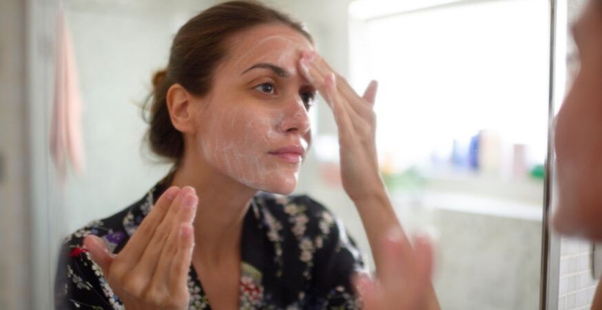 putting lotion on face